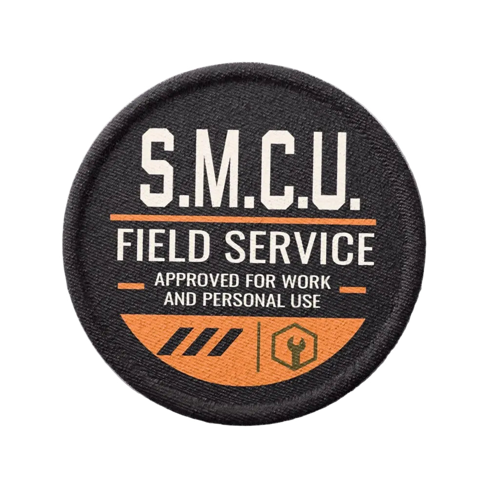A circular embroidered patch with a black background, featuring the text 'S.M.C.U Field Service Approved for work and personal use'